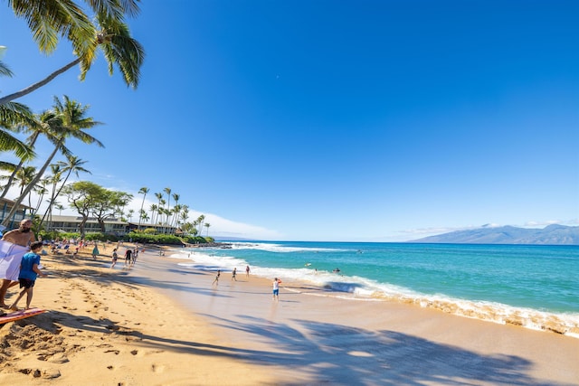 view of water feature with a mountain view and a beach view