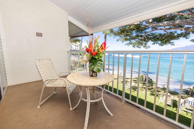 balcony with a beach view and a water view