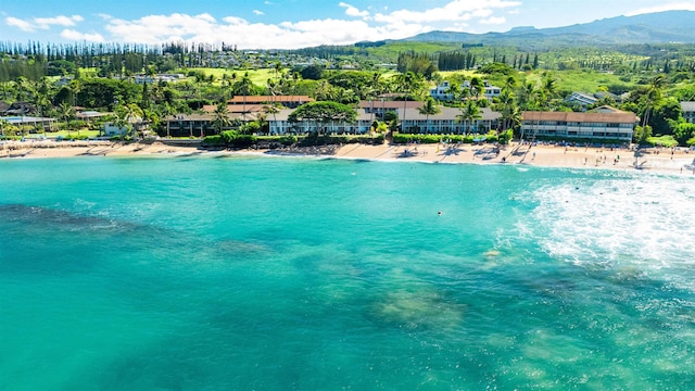 drone / aerial view featuring a beach view and a water and mountain view