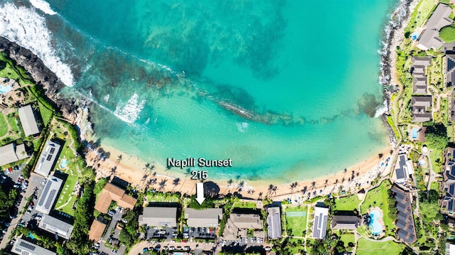 birds eye view of property with a water view and a view of the beach