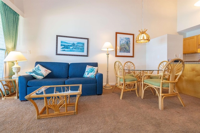 living room featuring a towering ceiling and carpet