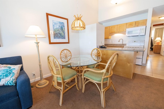 dining room with dark carpet and sink