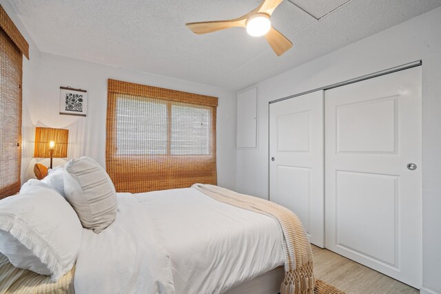 2495 S Kihei Rd Unit 175, Kihei, HI 96753 - bedroom featuring light wood-type flooring, a closet, a ceiling fan, and a textured ceiling