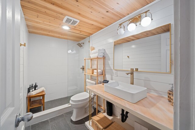 2495 S Kihei Rd Unit 175, Kihei, HI 96753 - bathroom featuring a sink, toilet, a tile shower, wood ceiling, and tile patterned flooring