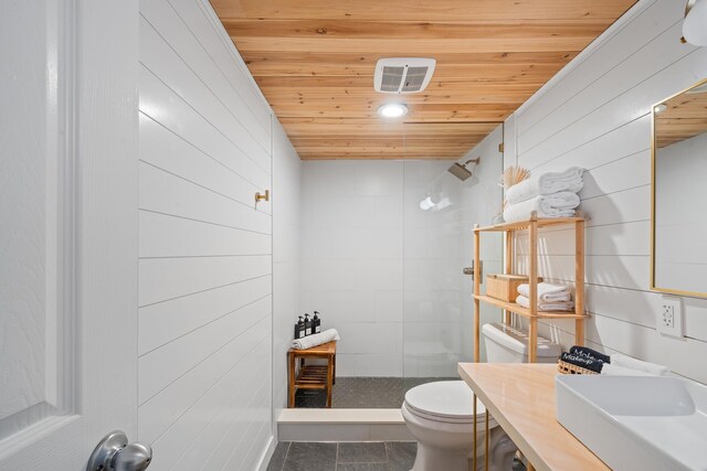 2495 S Kihei Rd Unit 175, Kihei, HI 96753 - full bathroom with a tile shower, toilet, wood ceiling, wood walls, and a sink