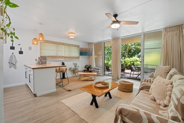 2495 S Kihei Rd Unit 175, Kihei, HI 96753 - living room featuring a ceiling fan, floor to ceiling windows, baseboards, and light wood finished floors