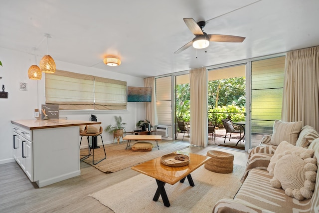 2495 S Kihei Rd Unit 175, Kihei, HI 96753 - living area featuring ceiling fan, light wood-type flooring, expansive windows, and baseboards