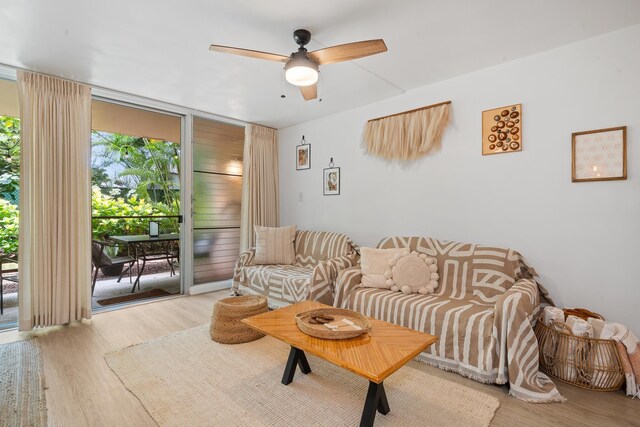 2495 S Kihei Rd Unit 175, Kihei, HI 96753 - living area with ceiling fan, wood finished floors, and a wall of windows