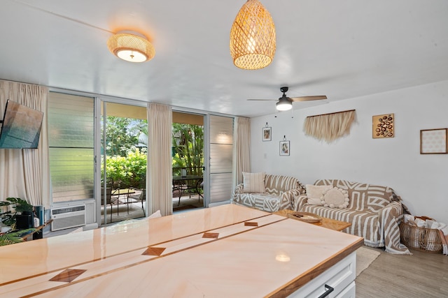 2495 S Kihei Rd Unit 175, Kihei, HI 96753 - living area with expansive windows, ceiling fan, wood finished floors, and cooling unit
