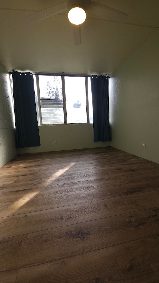 spare room featuring wood-type flooring and ceiling fan