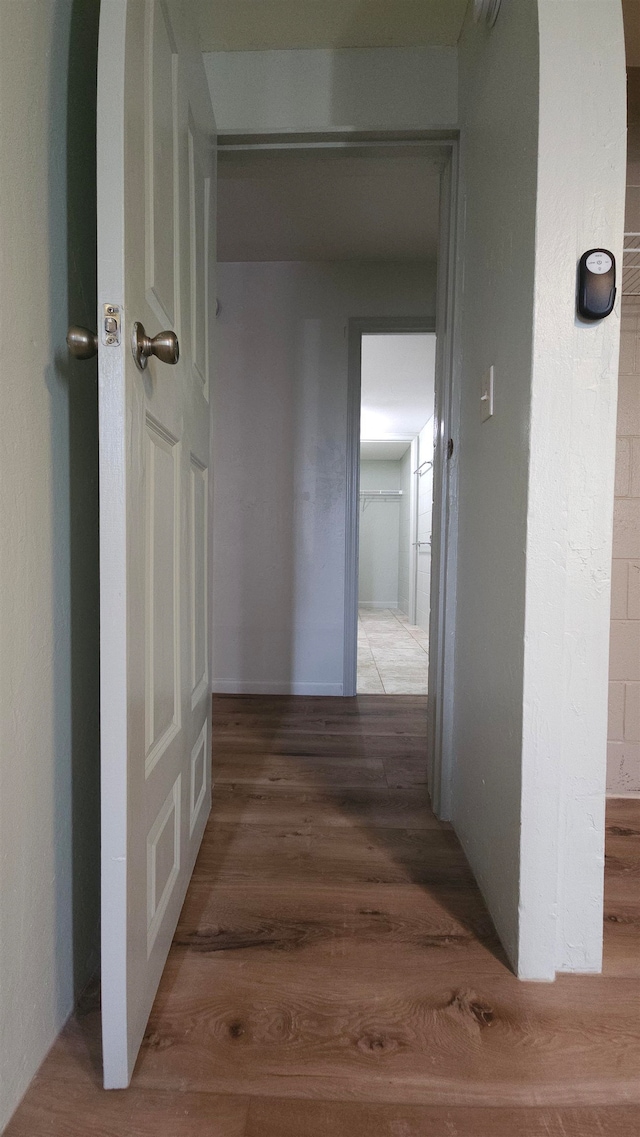 corridor with wood-type flooring