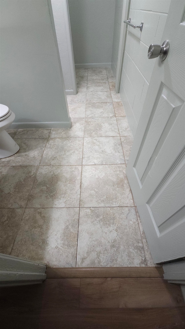 bathroom with tile patterned flooring and toilet