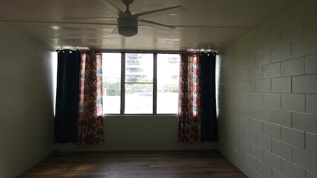 spare room with ceiling fan and wood-type flooring