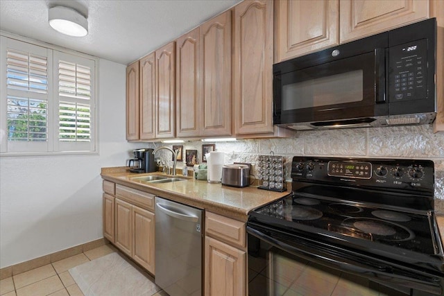 kitchen with black appliances, light tile patterned floors, light brown cabinets, sink, and backsplash