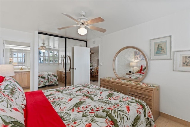 tiled bedroom with ensuite bathroom and ceiling fan