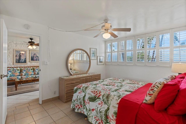 tiled bedroom featuring ceiling fan