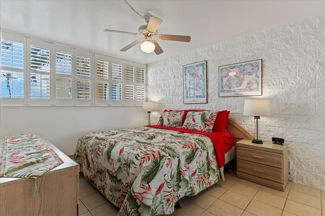 bedroom featuring ceiling fan, multiple windows, and light tile patterned floors