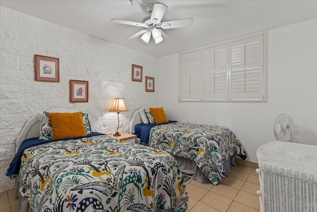 tiled bedroom featuring ceiling fan