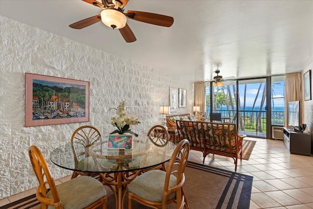 dining room featuring floor to ceiling windows, ceiling fan, and light tile patterned floors