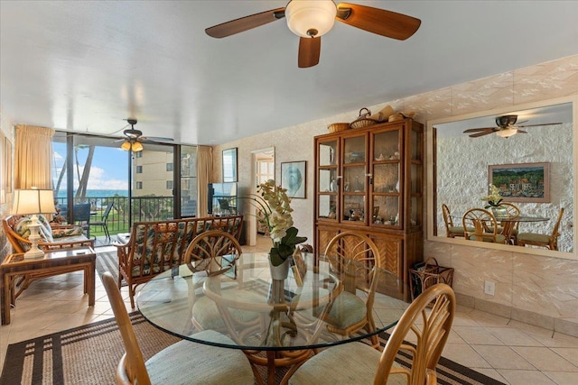 dining space with floor to ceiling windows and light tile patterned floors