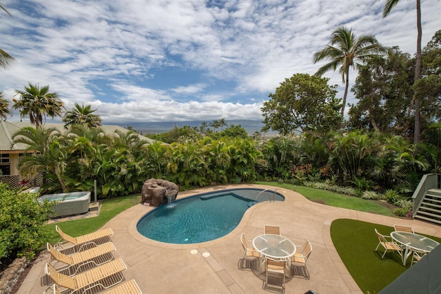 pool with a patio, a hot tub, and cooling unit