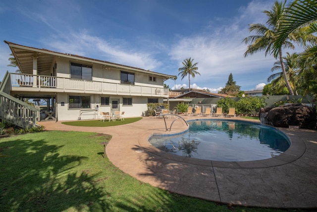 view of swimming pool with fence, stairs, a fenced in pool, a patio area, and a lawn