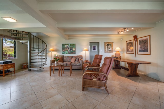 living area with light tile patterned flooring, stairs, and beam ceiling