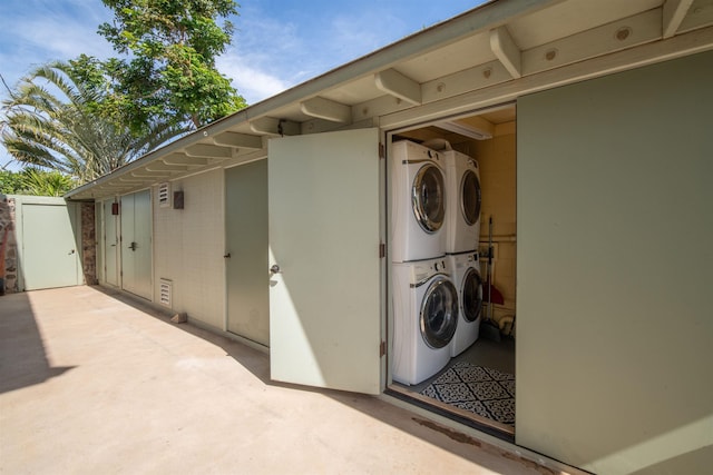 exterior space featuring laundry area, washer and clothes dryer, and stacked washer and clothes dryer