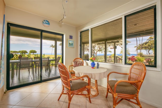 sunroom featuring baseboards and tile patterned floors