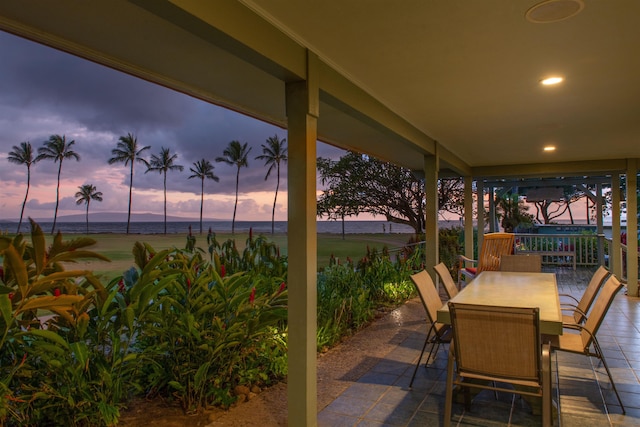 view of patio / terrace with outdoor dining space and a water view