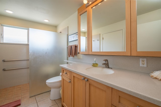 full bath with a walk in shower, toilet, tile patterned flooring, and vanity