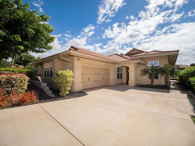 mediterranean / spanish house featuring a garage