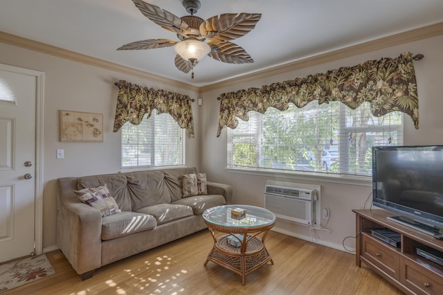 living area featuring light wood-style flooring, a wall mounted AC, ornamental molding, a ceiling fan, and baseboards