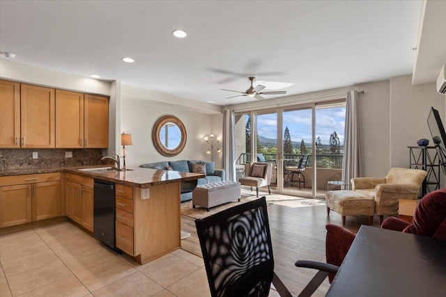 kitchen with dishwasher, sink, decorative backsplash, dark stone countertops, and kitchen peninsula