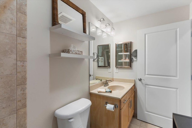 bathroom featuring tile patterned floors, vanity, and toilet