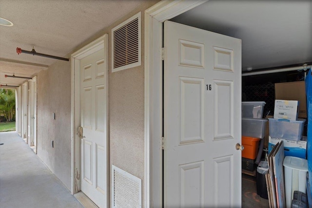 hall with a textured ceiling