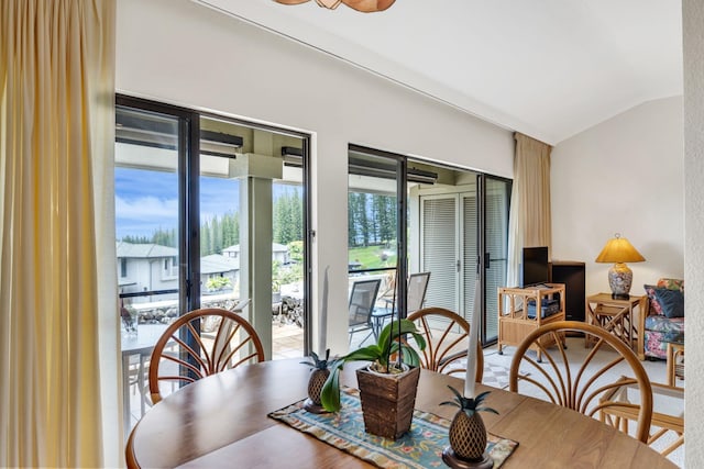 dining area featuring lofted ceiling