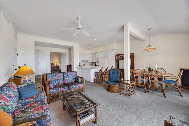 carpeted living area with lofted ceiling, visible vents, and a ceiling fan