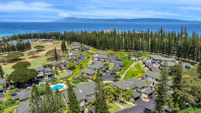 drone / aerial view featuring a water and mountain view and a residential view