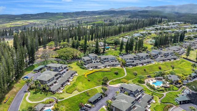 birds eye view of property featuring a residential view, a mountain view, and a wooded view