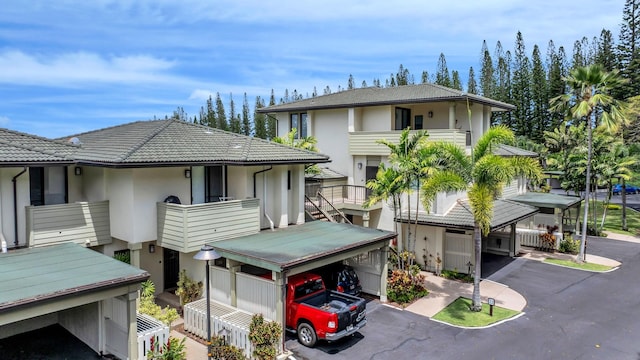 view of front of home with stucco siding and a tile roof