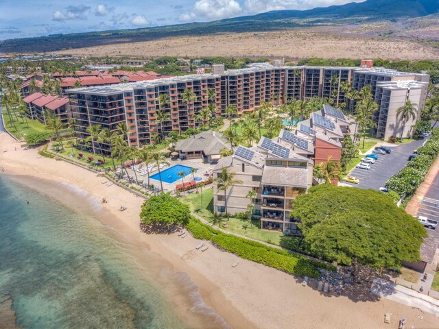 bird's eye view with a water view and a beach view