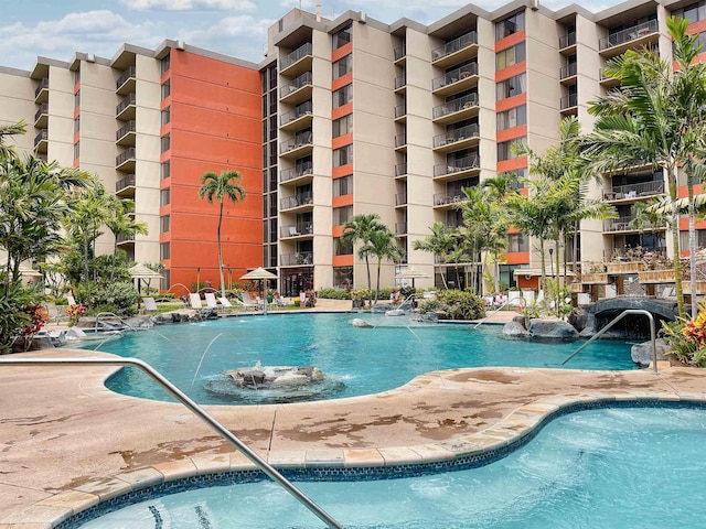 view of swimming pool with pool water feature