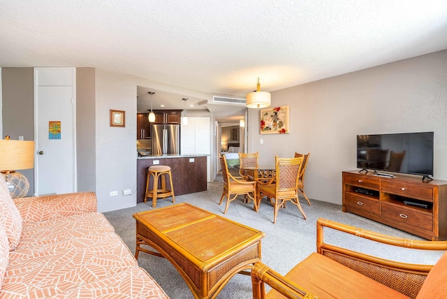 carpeted living room with a textured ceiling