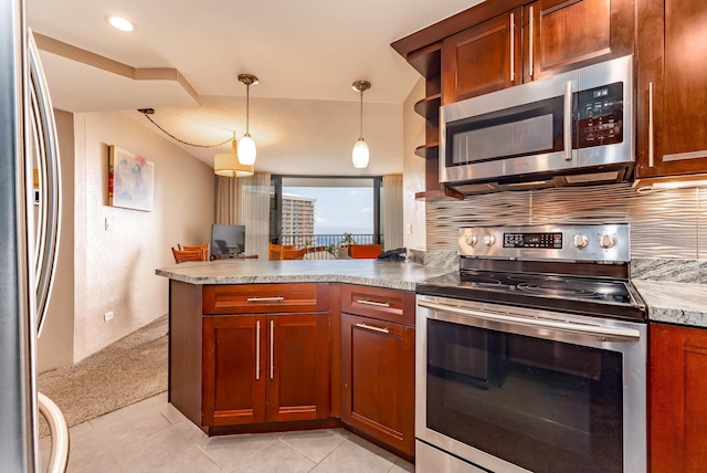 kitchen featuring light stone countertops, appliances with stainless steel finishes, light tile patterned floors, decorative light fixtures, and backsplash