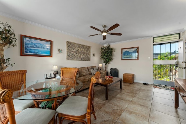 living area featuring light tile patterned floors, ceiling fan, baseboards, and crown molding