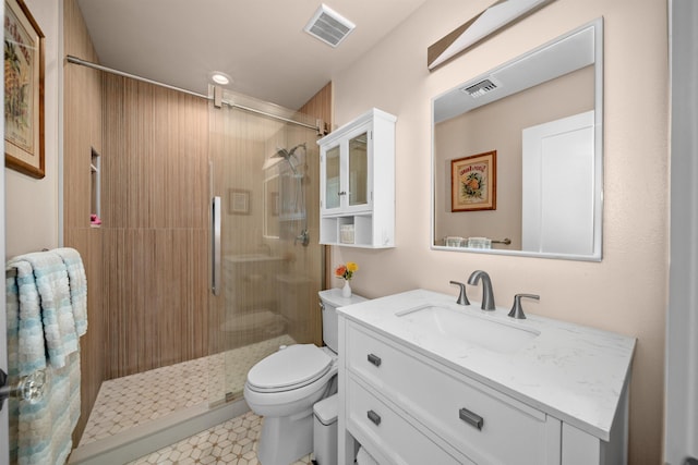 full bathroom featuring visible vents, vanity, toilet, and a shower stall