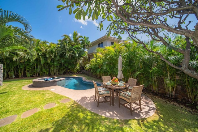 view of swimming pool with a yard, fence, a pool with connected hot tub, and a patio area