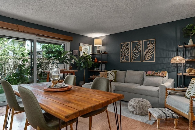 1299 Uluniu Rd Unit 103E, Kihei, HI 96753 - dining space with wood finished floors and a textured ceiling