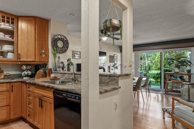 1299 Uluniu Rd Unit 103E, Kihei, HI 96753 - kitchen with black dishwasher, a sink, a textured ceiling, ceiling fan, and light wood-style flooring